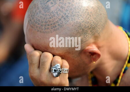 Bangkok. 15th Mar, 2014. A devotee attends the annual Tattoo Festival at Wat Bang Phra in Nakhon Pathom province of Thailand, March 15, 2014. Thousands of believers from all around Thailand and abroad travelled to attend the annual Tattoo Festival in Nakhon Pathom province. Credit:  Gao Jianjun/Xinhua/Alamy Live News Stock Photo