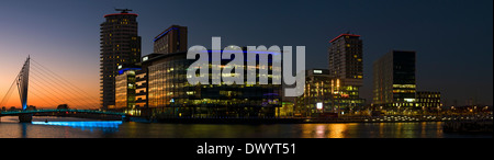 Panorama of the MediaCityUK complex and footbridge, over the Manchester Ship Canal at Salford Quays, Manchester, England, UK. Stock Photo