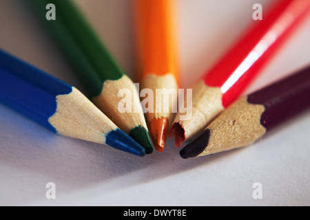 Crayons on paper board with pins together Stock Photo