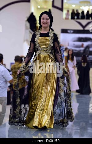 Sanaa, Yemen. 15th Mar, 2014. A model presents traditional Yemeni clothes in a fashion show held in Sanaa, Yemen, on March 15, 2014. The Yemeni culture ministry held a fashion show on Saturday, hoping to reactivate the tourist industry in the unrest-hit country by introducing Yemen's fascinating culture. Although there are large variety of traditional clothers in Yemen, a distinctive feature of Yemeni traditional costumes for women is the combination of dress and matching jewellery. Credit:  Xinhua/Alamy Live News Stock Photo