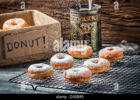 Icing sugar falling on fresh donuts Stock Photo