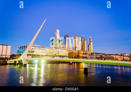 Women's Bridge and upscale skyscrapers at night in Puerto Madero neighborhood of Buenos Aires Stock Photo