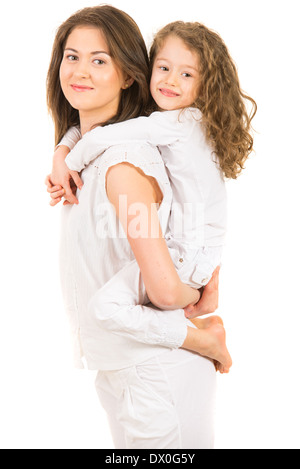 Mother giving piggyback ride to her daughter and being in motion isolated on white background Stock Photo