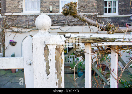 Close up of broken fence with a fallen tree caused by a storm Stock Photo