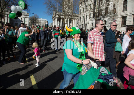 London, UK. Sunday 16th March 2014. Revellers gather in central London for the annual St Patrick’s Day celebrations. Saint Patrick's Day or the Feast of Saint Patrick is a cultural and religious holiday celebrated annually on 17 March, the death date of the most commonly-recognised patron saint of Ireland, Saint Patrick. Nowadays the celebration is a fun excuse for some craic and lots of drinking. Credit:  Michael Kemp/Alamy Live News Stock Photo