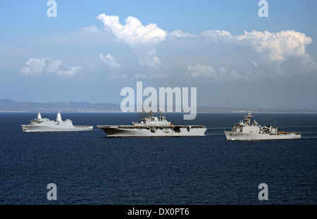 US Navy amphibious assault ship USS Makin Island alongside dock landing ship USS Comstock and amphibious transport dock ship USS San Diego during sea qualifications in preparation for its upcoming scheduled deployment March 13, 2014 in the Pacific Ocean. Stock Photo