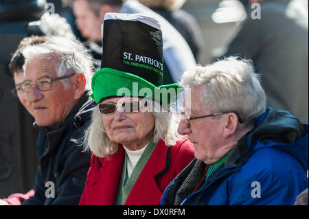 London, UK. 16 March 2014. An elderly woman wearing an Irish novelty hat as she watches the annual St Patrick's day parade in London.  Photographer:  Gordon Scammell/Alamy Live News Stock Photo