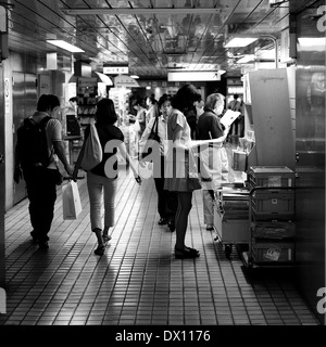 Woman Reading In Underground Shinjuku, Tokyo, Japan Stock Photo