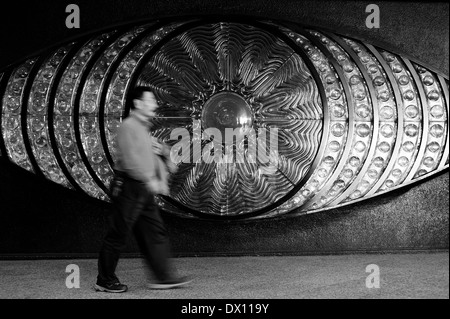 Man Walking In Front Of The Shinjuku Eye, Shinjuku Underground, Tokyo, Japan Stock Photo