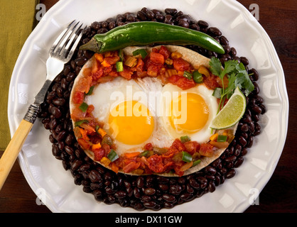 Mexican flour tortilla, salsa, peppers and eggs. Stock Photo