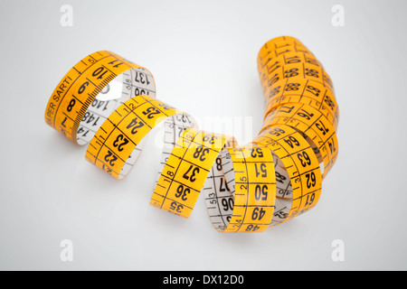 Yellow measuring tape isolated on white background Stock Photo