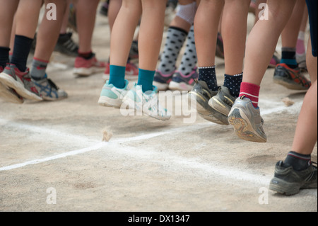 Kids jumping during Japanese elementary school sports day in Tokyo, Japan Stock Photo