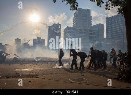 Caracas, Venezuela. 16th Mar, 2014. Demonstrators clash with members of the Bolivarian National Guard during a protest in Altamira, in the municipality of Chacao, east of Caracas, Venezuela, on March 16, 2014. Credit:  Manuel Hernandez/Xinhua/Alamy Live News Stock Photo