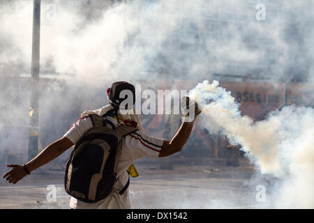 Caracas, Venezuela. 16th Mar, 2014. A demonstrator throws an object during a protest in Altamira, in the municipality of Chacao, east of Caracas, Venezuela, on March 16, 2014. Credit:  Manuel Hernandez/Xinhua/Alamy Live News Stock Photo