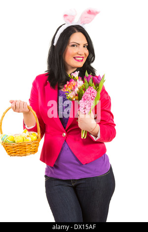 Beauty woman with bunny ears,basket with Easter eggs and fresh flowers of spring isolated on white background Stock Photo