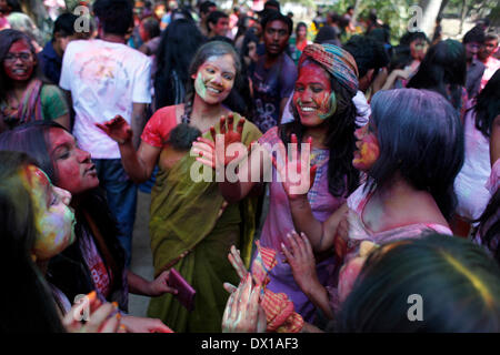 Dhaka, Bangladesh. 16th Mar, 2014. University students celebrate the festival of colour after smearing each other with coloured powder during Holi Festival in Dhaka, Bangladesh, 16 March 2014. Holi, which literally means 'burning', is celebrated on the full moon day in the month of Phalguna and heralds the onset of spring season (Photo by Mohammad Asad / Pacific Press) Credit:  PACIFIC PRESS/Alamy Live News Stock Photo