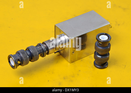 Used BNC connectors on yellow surface of device Stock Photo