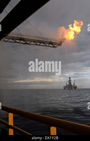 Gas from the damaged Deepwater Horizon oil well is burned off by the drill ship Discoverer Enterprise as clean up continues in the biggest oil spill in history May 16, 2010 in the Gulf of Mexico. Stock Photo