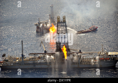 The drill ship Discoverer Enterprise and Q4000 burn off gas from the uncapped Deepwater Horizon wellhead as clean up continues in the largest oil disaster in history June 26, 2010 in the Gulf of Mexico. Stock Photo