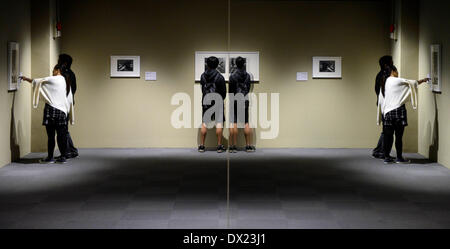 Taipei, China's Taiwan. 17th Mar, 2014. Visitors look at works of Maurits Cornelis Esher, the famous Dutch print artist, at an art show in Taipei, southeast China's Taiwan, March 17, 2014. The exhibition 'The Enigma of M. C. Escher: Prints from the Israel Museum, Jerusalem', which lasts from Feb. 27 to June 2, includes Escher's best works, all from the collection of the Israel Museum, Jerusalem. Credit:  Huang Xiaoyong/Xinhua/Alamy Live News Stock Photo