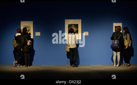 Taipei, China's Taiwan. 17th Mar, 2014. Visitors look at works of Maurits Cornelis Esher, the famous Dutch print artist, at an art show in Taipei, southeast China's Taiwan, March 17, 2014. The exhibition 'The Enigma of M. C. Escher: Prints from the Israel Museum, Jerusalem', which lasts from Feb. 27 to June 2, includes Escher's best works, all from the collection of the Israel Museum, Jerusalem. Credit:  Huang Xiaoyong/Xinhua/Alamy Live News Stock Photo