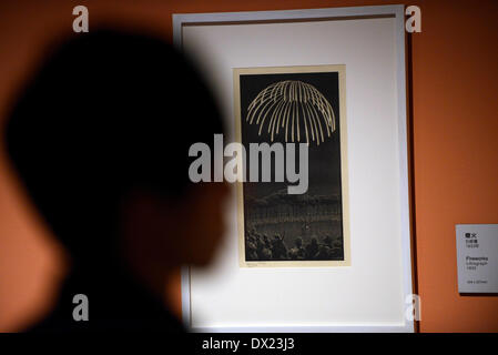 Taipei, China's Taiwan. 17th Mar, 2014. A visitor looks at a work of Maurits Cornelis Esher, the famous Dutch print artist, at an art show in Taipei, southeast China's Taiwan, March 17, 2014. The exhibition 'The Enigma of M. C. Escher: Prints from the Israel Museum, Jerusalem', which lasts from Feb. 27 to June 2, includes Escher's best works, all from the collection of the Israel Museum, Jerusalem. Credit:  Huang Xiaoyong/Xinhua/Alamy Live News Stock Photo