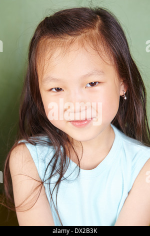 Portrait of a smiling chinese girl in front of a chalkboard Stock Photo