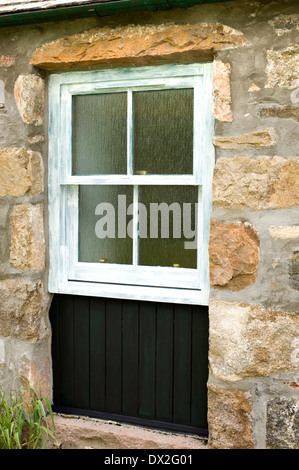 Image a sash window and boarding in old stone cottage undercoated and ready to be painted Stock Photo