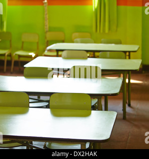 Empty classroom in a elementary school with tables and chairs Stock Photo
