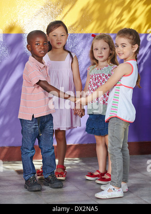 Interracial group of children learning dancing in a school class Stock Photo