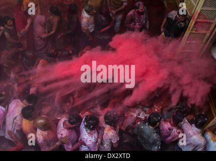 Calcutta. 17th Mar, 2014. Indian people sprinkle colour powder on the crowds at a temple during the celebration of Holi festival, also known as festival of colors, in Calcutta, capital of eastern Indian state West Bengal, March, 17, 2014. The Holi festival is a popular Hindu spring festival observed in India at the end of winter season on the last full moon day of the lunar month. Credit:  Tumpa Mondal/Xinhua/Alamy Live News Stock Photo