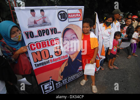 Central Java, Indonesia. 15th Feb, 2013. MARCH 15: Participant from the Hanura party hold banners take part on parade to mark opening of Indonesia election campaign in Indonesia on March 15, 2014 in Solo, Central Java, Indonesia. Indonesian elections will be held on April 9, 2014 while voting to Indonesia President election held July 9, 2014. Indonesia election followed by 12 parties with 180 million voters to take the part. © Sijori Images/ZUMAPRESS.com/Alamy Live News Stock Photo