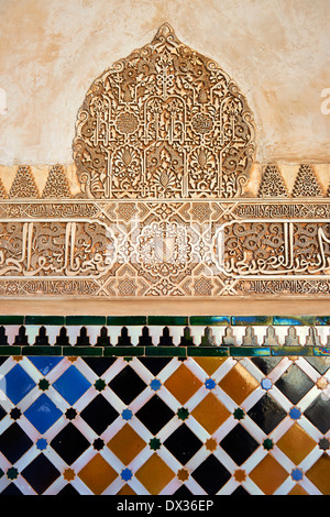 Moorish arabesque ceramic tiles sculpted plasterwork of the Palacios Nazaries, Alhambra. Granada, Andalusia, Spain.  Stock Photo
