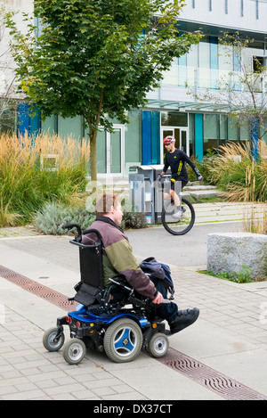 Motorized wheel chair and unicycle on paths Stock Photo
