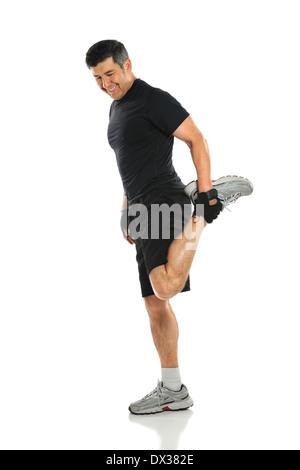 Hispanic senior stretching leg isolated over white background Stock Photo