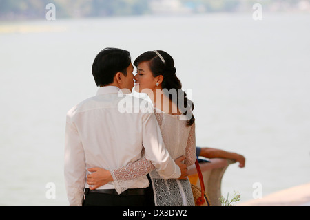 A Vietnamese couple having their engagement photographs taken by the Hoan Kiem Lake in Hanoi Stock Photo