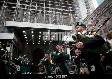 New York, USA. 17th Mar, 2014. Bagpippers march in the St. Patrick's Day parade, Monday, March 17, 2014 in New York.  St. Patrick's Cathedral, center, is wrapped in scaffolding for renovations. Photo by Yeong-Ung Yang Credit:  Yeong-Ung Yang/Alamy Live News Stock Photo