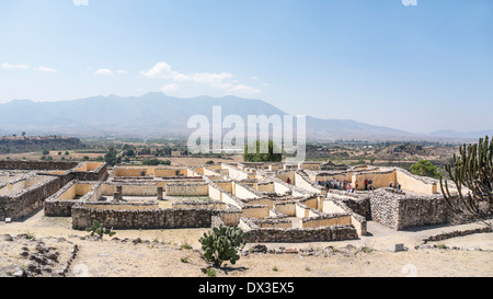 view looking south down on Palace of 6 Patios with American tour group examining Patio A ruins of ancient city of Yagul Oaxaca Stock Photo