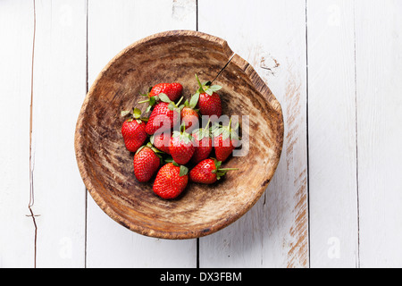 Strawberry in bowl on white wooden background Stock Photo