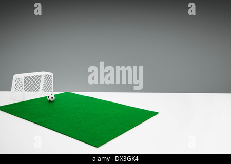 Tabletop Goal Posts Small table top football goal posts, football and green felt pitch on ...