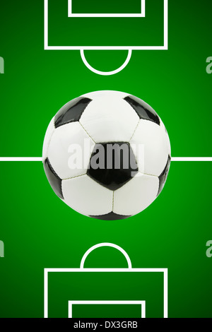 Black and white leather Football on Digitally Illustrated green football pitch background Stock Photo