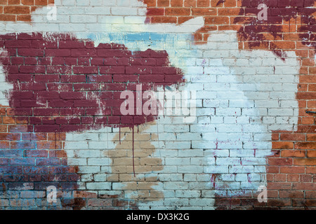 background texture of a grunge brick wall with graffiti painted over Stock Photo