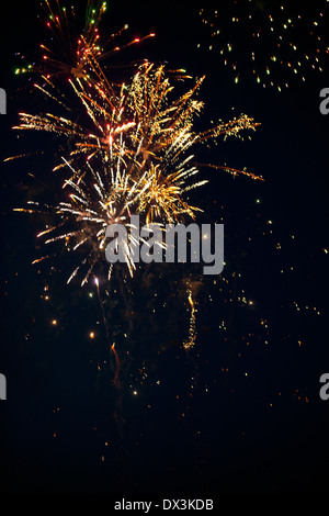 Fireworks exploding in night sky, low angle view Stock Photo