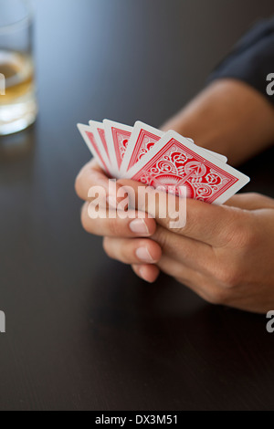 Man playing poker with playing cards, close up, high angle view Stock Photo