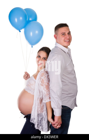 Happy pregnant couple holding balloons for their baby Stock Photo