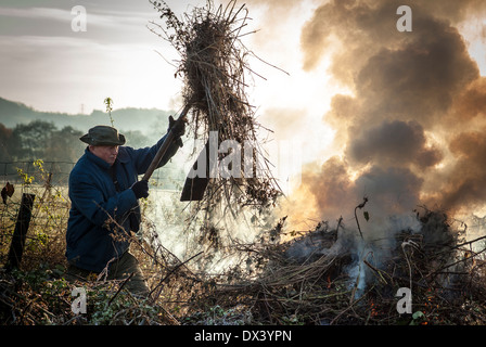 Burning dry garden refuse on a bonfire in the country Stock Photo