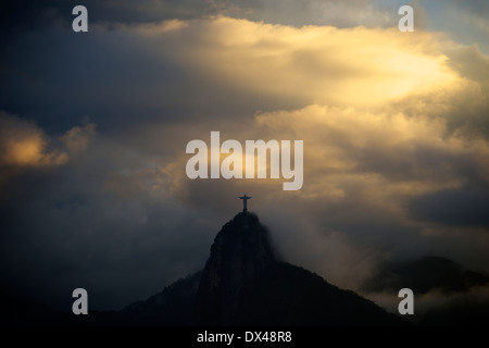 Christ the Redeemer statue appearing through the clouds on top of Corcovado mountain,Rio de Janeiro, Stock Photo