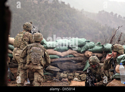 US Army soldiers with the 101st Airborne Division return fire during a firefight with the Taliban March 29, 2011 in the valley of Barawala Kalet, Kunar province Afghanistan. Stock Photo