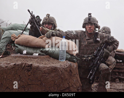 US Army soldiers with the 101st Airborne Division take cover during a firefight March 29, 2011 in the valley of Barawala Kalet, Kunar province Afghanistan. Stock Photo