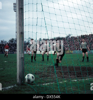 football, Regionalliga West, 1963/1964, Stadium an der Hafenstrasse, Rot Weiss Essen versus VfB Bottrop 7:2, Eckehard Feigenspan (RWE) scores the 1:0, f.l.t.r. the VfB players Guenter Mikolaiczak, Alfred Kubitza, keeper Rolf Kornas and Hermann Koopmann Stock Photo